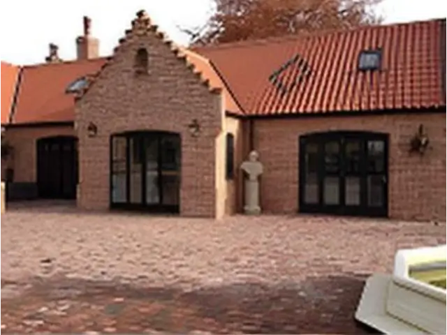 Black-framed glazed doors on a gabled brick house